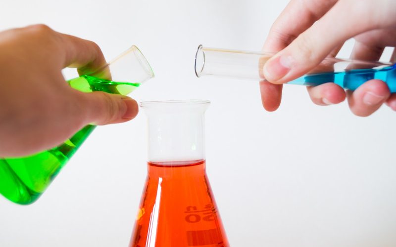 person holding laboratory flasks