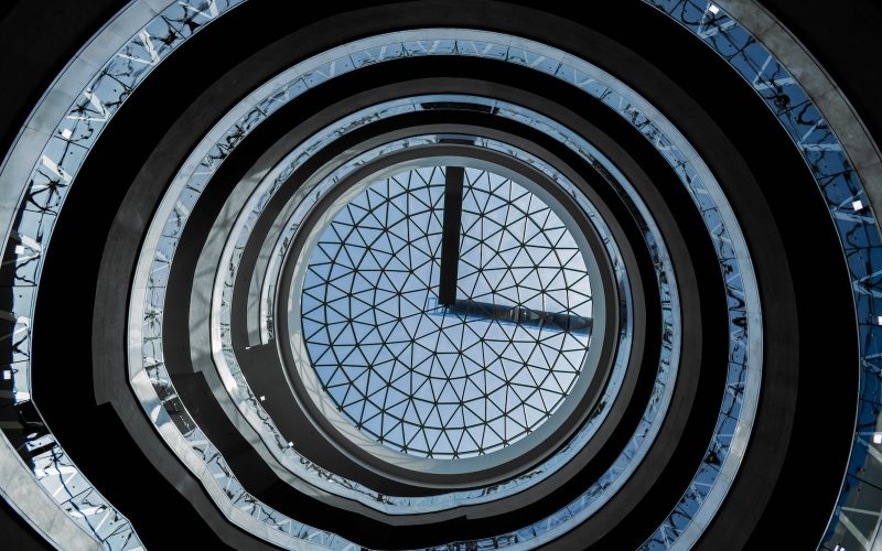 a very tall clock sitting inside of a building